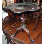 A mahogany petal topped pedestal wine table, set on decorative pillar and acanthus carved tripod