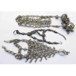 An Eastern white metal tassel chain and two ornate hand panga