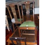 A set of four Edwardian mahogany framed high back dining chairs with decorative splats and drop-in