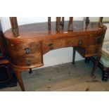 A 3' 9" 1930's walnut book match veneered kidney shaped dressing table with frieze drawer and four