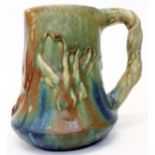 An early 20th Century Nils de Barck Japonist pottery mug with moulded tree design and metallic