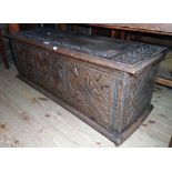 A 3' 5" antique carved oak coffer with triple repeat design to front and later hinges