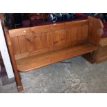 A 5' 3" old waxed pitch pine pew with incised roundels to standard ends