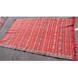 A Moroccan flat weave rug with repeat geometric bands and alternating geometric side borders,