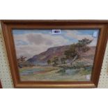 Albert Stevens: a gilt framed watercolour, depicting a country landscape with hills in distance -