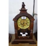 A late 19th Century American stained wood cased shelf clock with spring driven gong striking