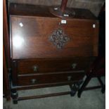 A 29" James Phillips polished oak bureau with part fitted interior and two long graduated drawers