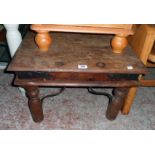A 24" Eastern hardwood and iron studded coffee table with iron brackets and turned legs
