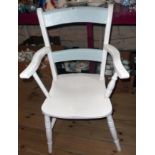 A later painted antique Windsor elbow chair with solid seat, set on ring turned supports