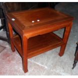 A 24" Chinese hardwood two tier occasional table set on typical moulded supports