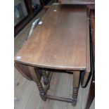 A 36" 20th Century oak gateleg table, set on turned supports