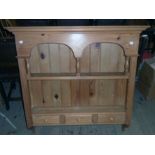A 3' 3 1/2" modern waxed pine wall mounted plate rack with arcaded and spindle set decoration to