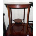 A 23" diameter Edwardian mahogany and strung two tier occasional table, set on swept square