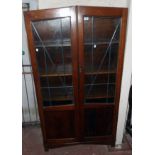 A 36" 1930's polished oak book cabinet with five shelves enclosed by a pair of part leaded glazed