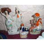 Three Staffordshire figures, comprising Little Red Riding Hood spill vase and two couples