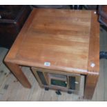 A pair of 26" teak tea tables, set on moulded legs