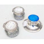 A pair of silver flip-top glass inkwells - sold with an enamel topped silver capstan similar