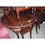 A Victorian mahogany D-end extending dining table with single leaf and winder, set on acanthus