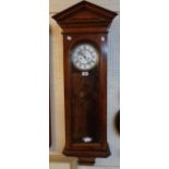 A late 19th Century polished walnut cased German regulator wall clock with visible pendulum and