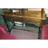 A 3' 9" 20th Century polished oak side table in the antique style with two frieze drawers, set on