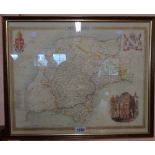 A framed reproduction coloured map print of Devonshire