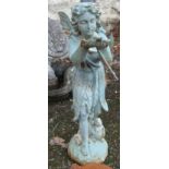 A painted cast iron garden fairy standing and holding a bird