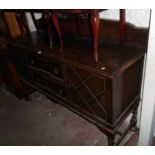 A 5' 6" early 20th Century polished oak sideboard with low raised back, two central drawers and