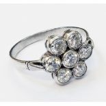 An unmarked white metal ring, set with a cluster of seven diamonds