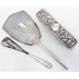 A silver backed hand mirror, shoe horn and brush - various styles and condition