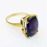 A marked 9ct. yellow metal ring, set with large cushion cut amethyst stone - with certificate for