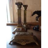 A pair of brass corinthian column candlesticks - sold with a cast brass flip-top stamp box