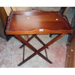 A 20th Century stained wood butler's tray on folding stand