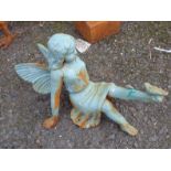 A painted cast iron garden seated fairy with bird