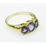 An import marked 375 gold ring set with three amethysts