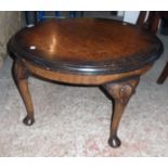 A 27" diameter reproduction figured walnut tea table, set on fan carved legs with pad feet