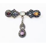 A marked 925 white metal suspender brooch, set with various coloured stones