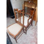 An Edwardian walnut and strung elbow chair, with studded upholstery to seat and square tapered front