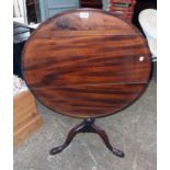 A 30" diameter late Georgian mahogany tilt-top table, set on turned pillar and tripod base with