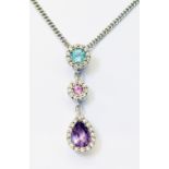 A marked 18k/750 triple drop multi-stone pendant with diamond borders, on import marked 375 white