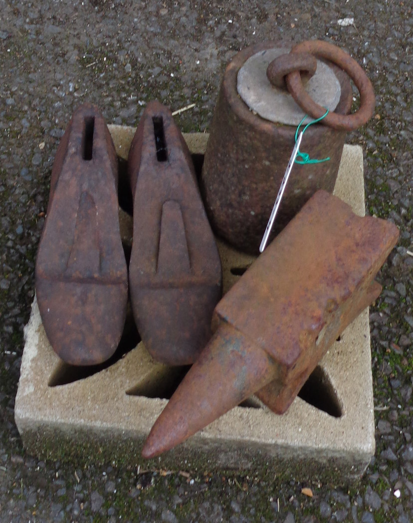 A small anvil, large weight and two shoe lasts