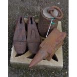 A small anvil, large weight and two shoe lasts