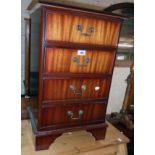 A 17" reproduction mahogany four drawer bedside chest, set on bracket feet