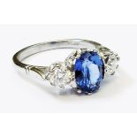 A marked PLAT white metal ring, set with central 2.10ct. oval sapphire flanked by two diamonds - 0.