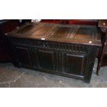 A 4' 1" antique oak three panel coffer with moulded decoration and panelled sides