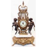 A 24 1/2" reproduction ornate brass and marble cased salon mantel clock with flanking figures and