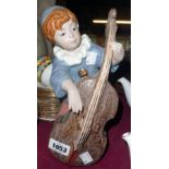 A continental pottery figure of a boy playing a double bass
