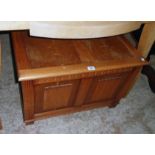 A 31" 20th Century stained mixed wood lift-top linen chest with linen-fold decoration to front