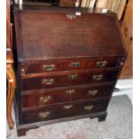 A 35" late Georgian oak bureau with fitted interior and four long graduated drawers under set on