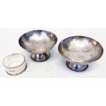 A pair of Eastern soft white metal pedestal bon-bon dishes with pricket writing - sold with a silver