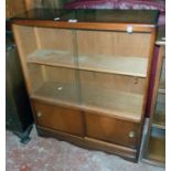 A 30" vintage stained mixed wood book cabinet with sliding glass doors to top and further sliding